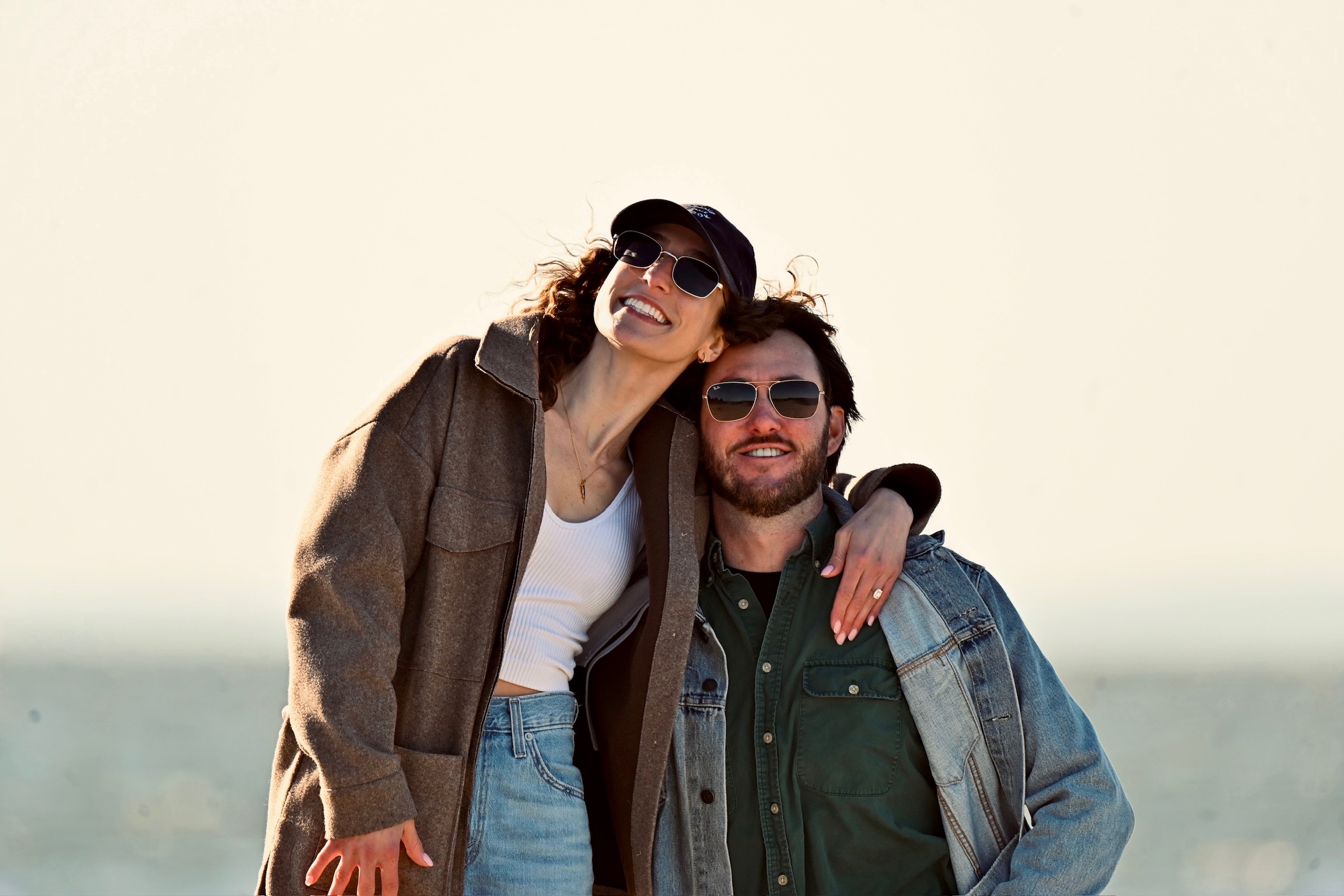 Eric and Mary smiling together by the water